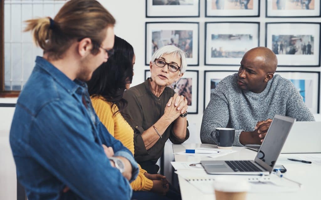 business people with laptop having a discussion in office